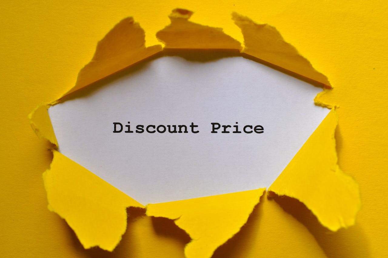Eye-catching image of torn yellow paper revealing the words 'Discount Price.'